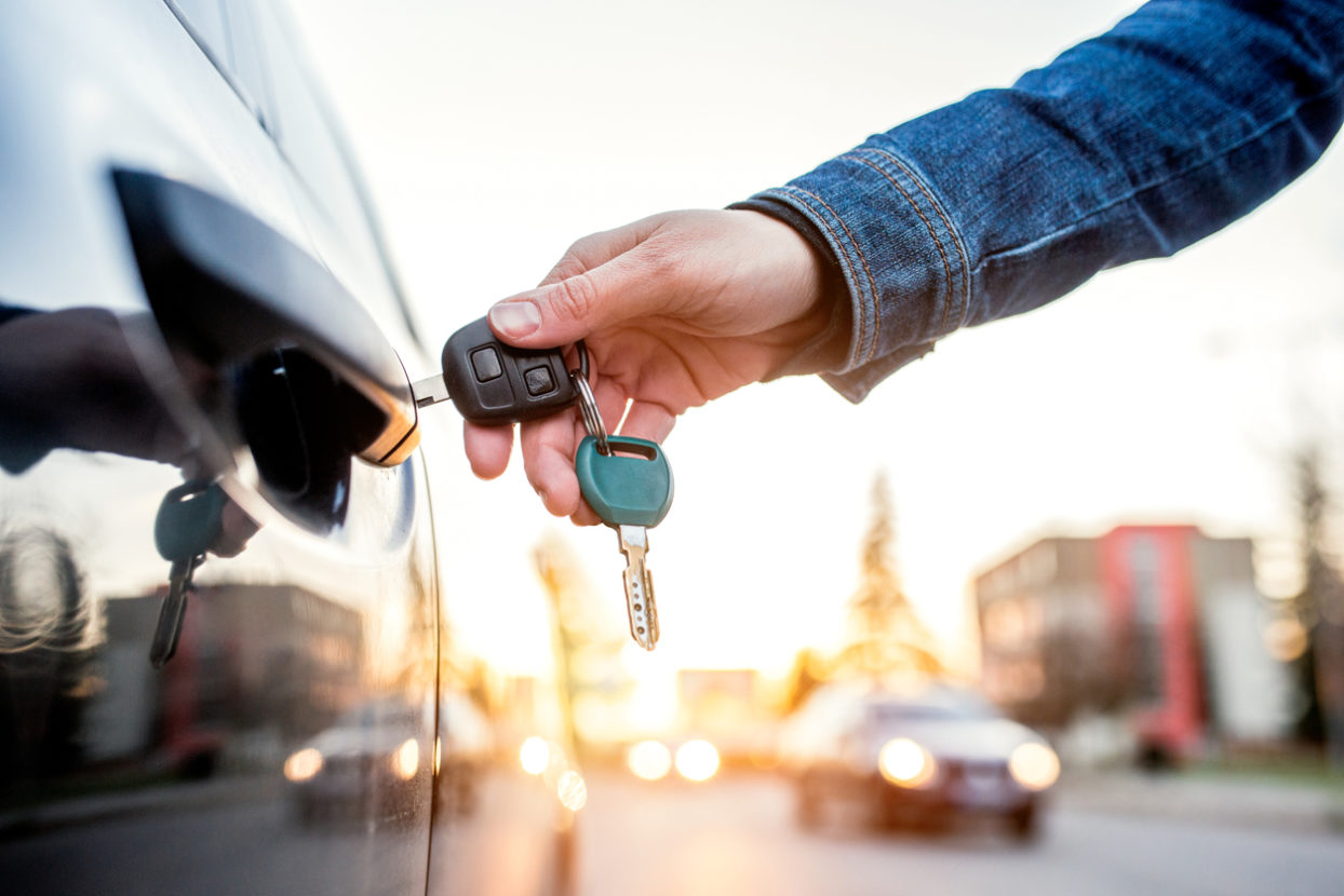 This is a photo of someone inserting a key into a vehicle lock.